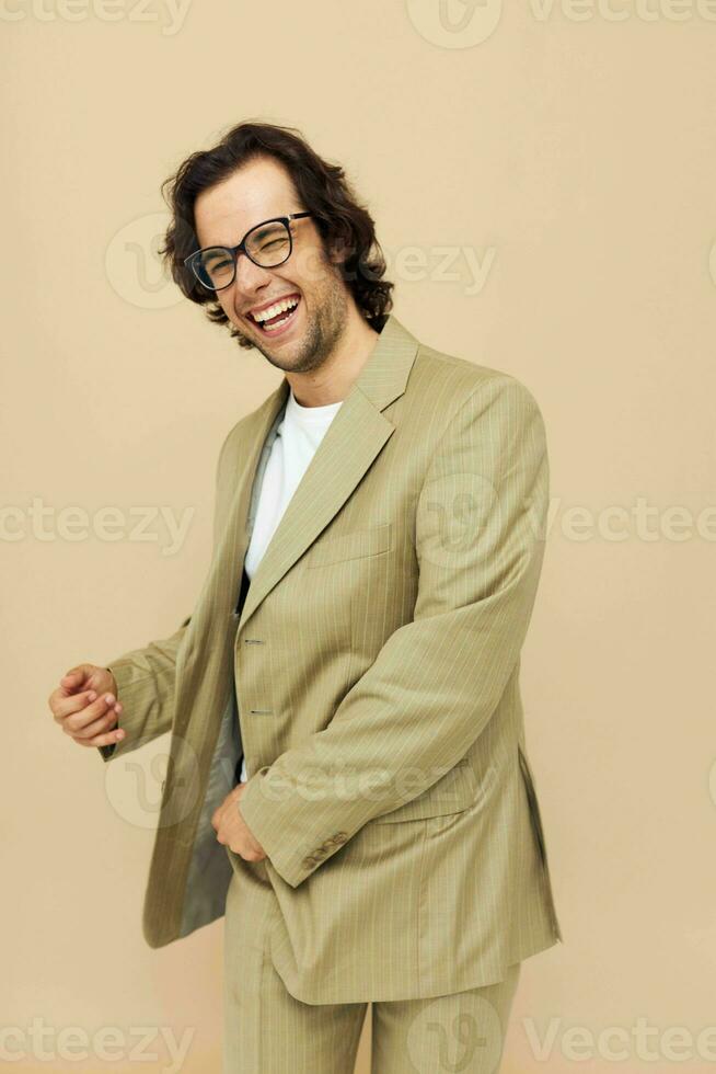 Cheerful man with glasses emotions gesture hands posing beige background photo