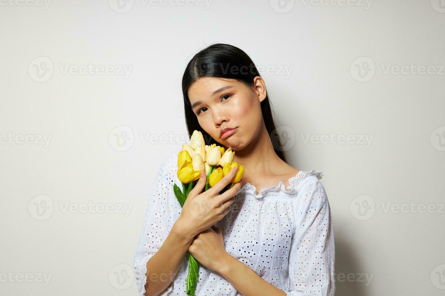 woman in a white shirt flowers spring posing light background unaltered photo
