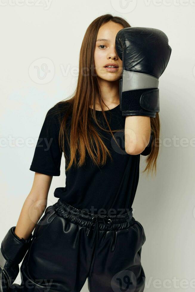 beautiful girl in black sports uniform boxing gloves posing fitness training photo