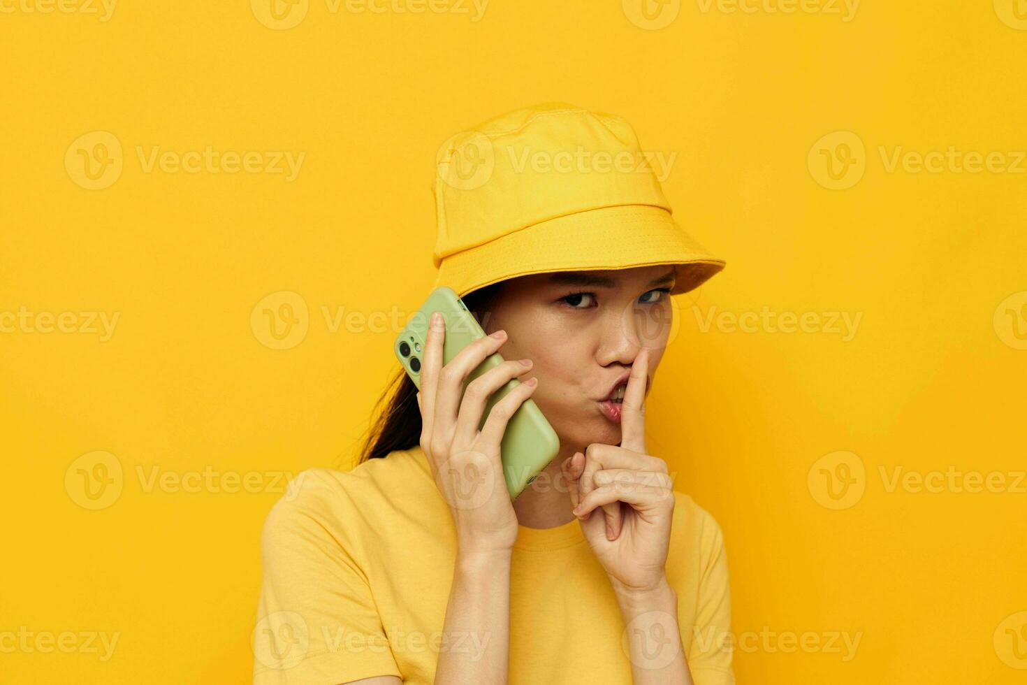 Charming young Asian woman holding a phone posing lifestyle technology studio model unaltered photo