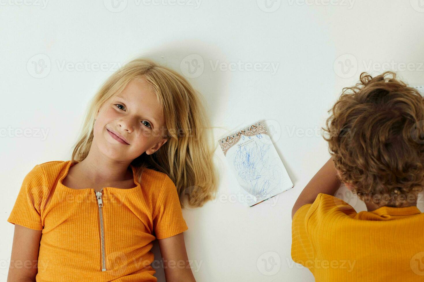 cheerful children emotions drawing together notepad and pencils light background unaltered photo