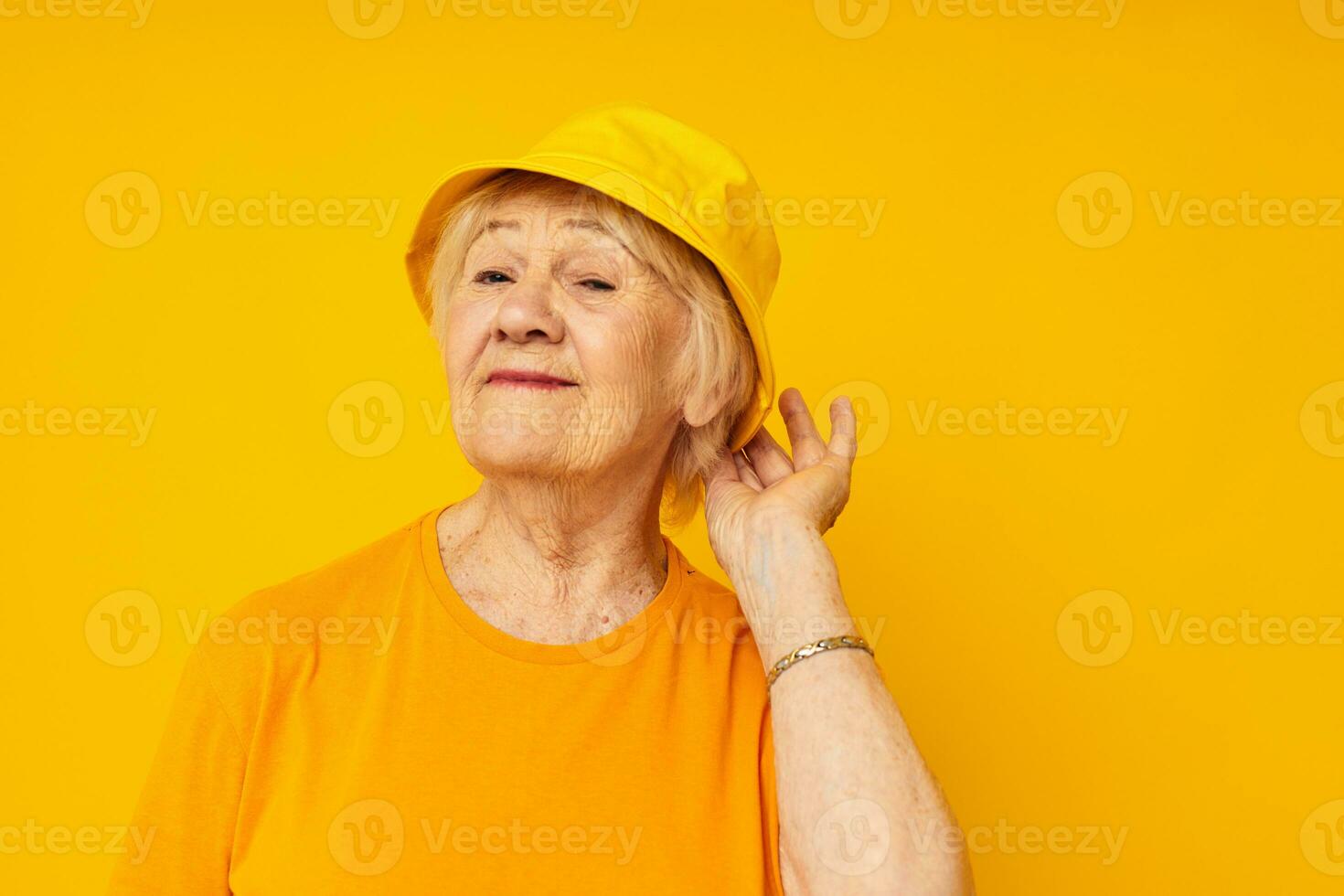 smiling elderly woman happy lifestyle in a yellow headdress close-up emotions photo