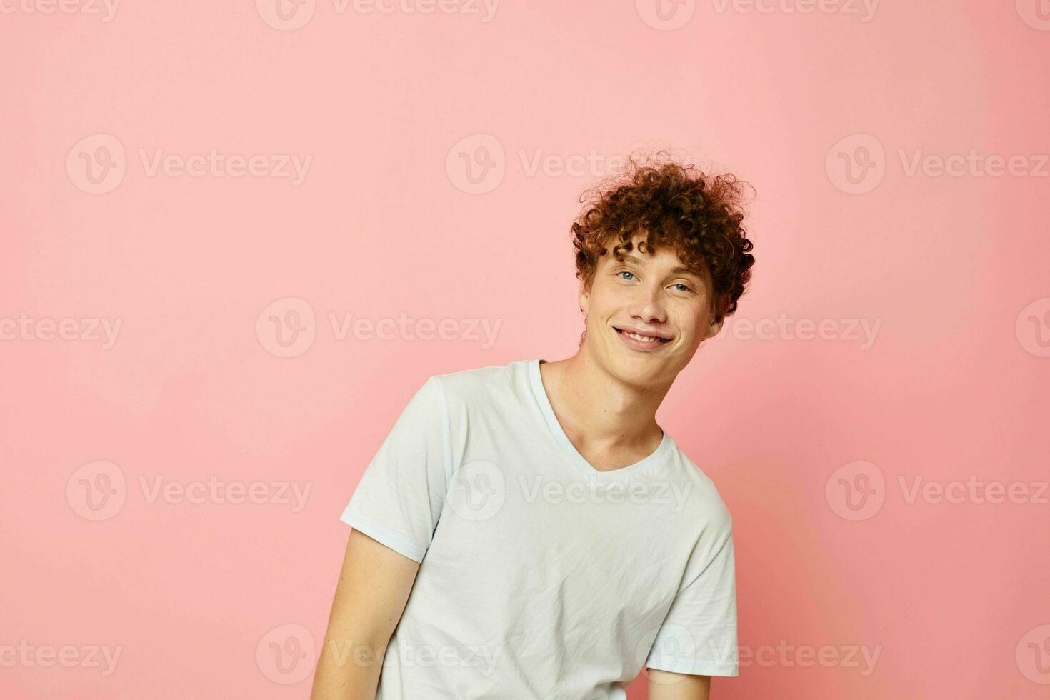 portrait of a young curly man summer clothes white tshirt posing Lifestyle unaltered photo