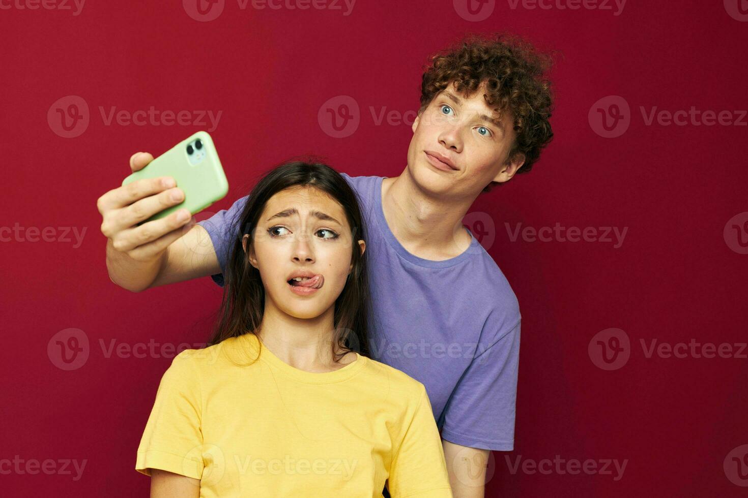 nice guy and girl in colorful T-shirts with a phone Youth style photo