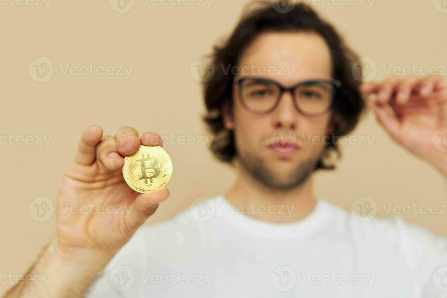 handsome man with glasses gold bitcoin in hands Lifestyle unaltered photo