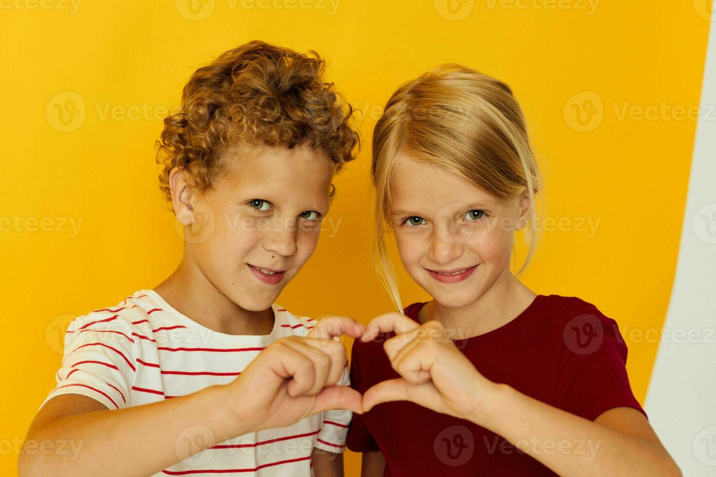 Portrait of cute children cuddling fashion childhood entertainment on colored background photo