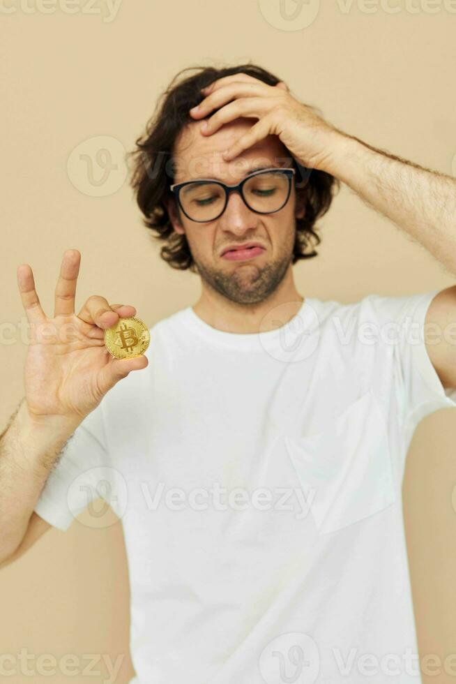 handsome man in a white T-shirt with Bitcoin cryptocurrency isolated background photo