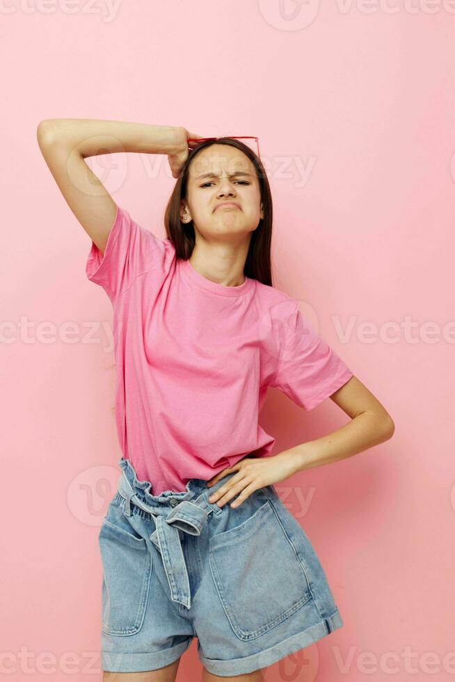 young beautiful woman in a pink t-shirt casual clothes pink background photo