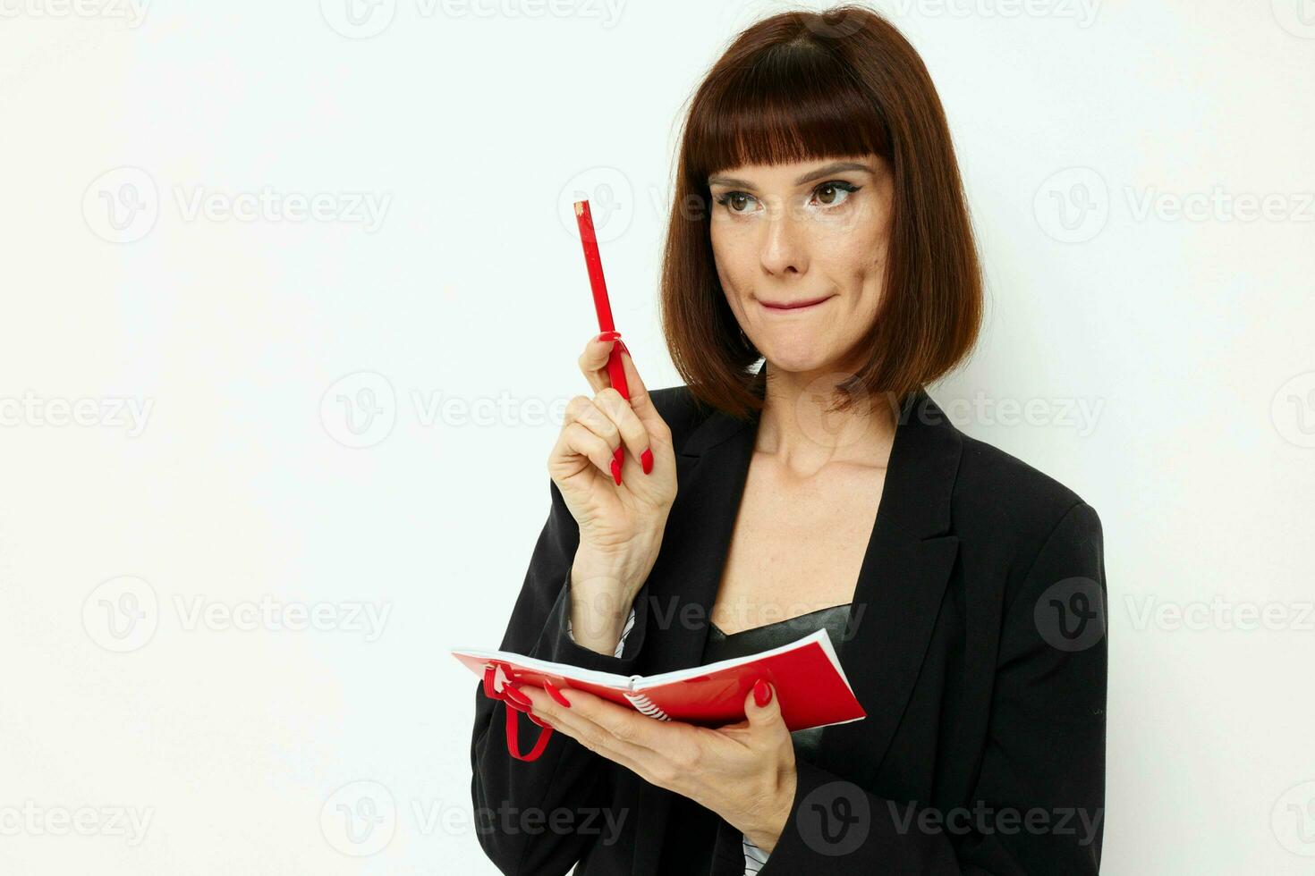 portrait of a woman writing in a notebook black jacket Lifestyle unaltered photo