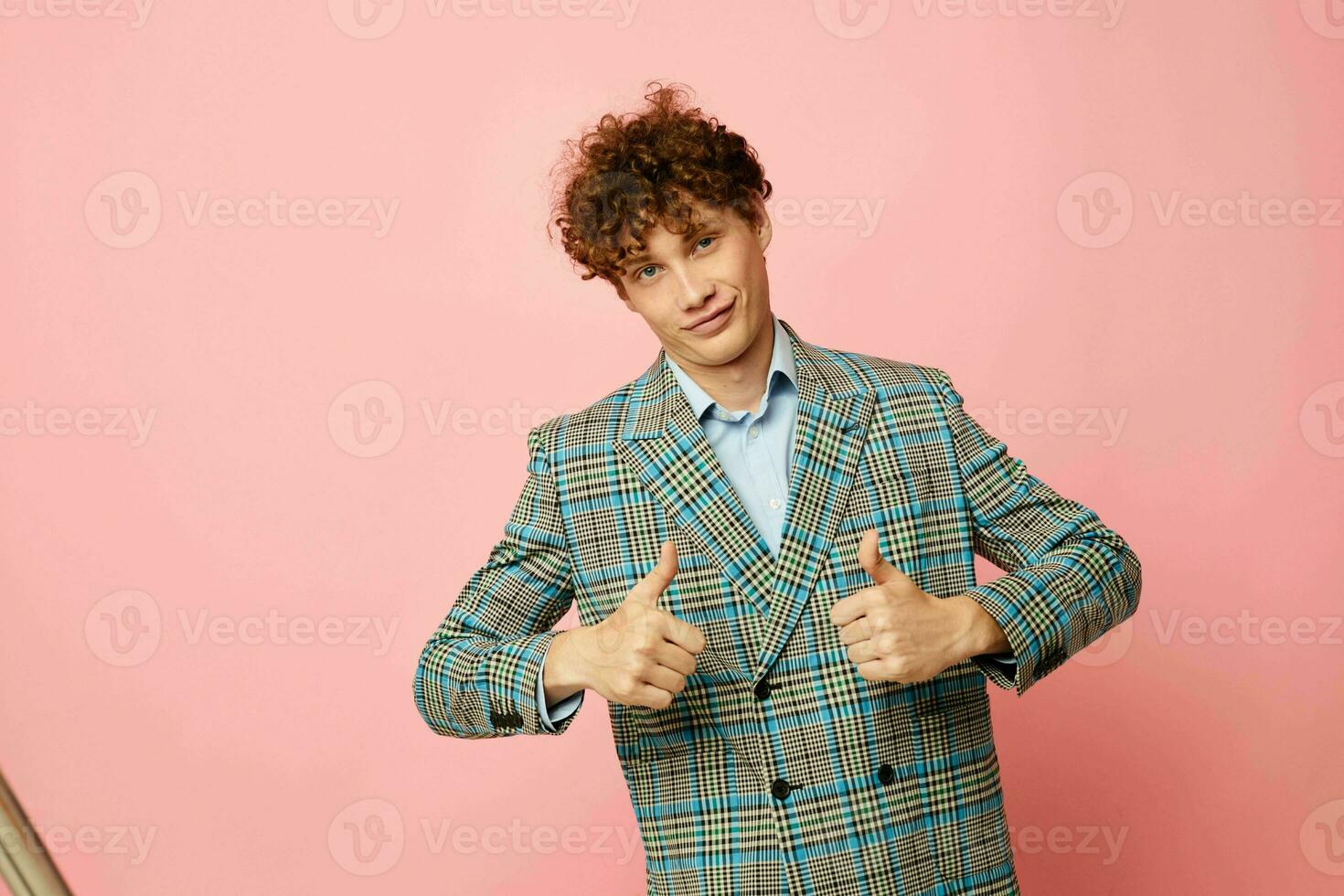 portrait of a young curly man gesturing with his hands emotions checkered jacket Lifestyle unaltered photo