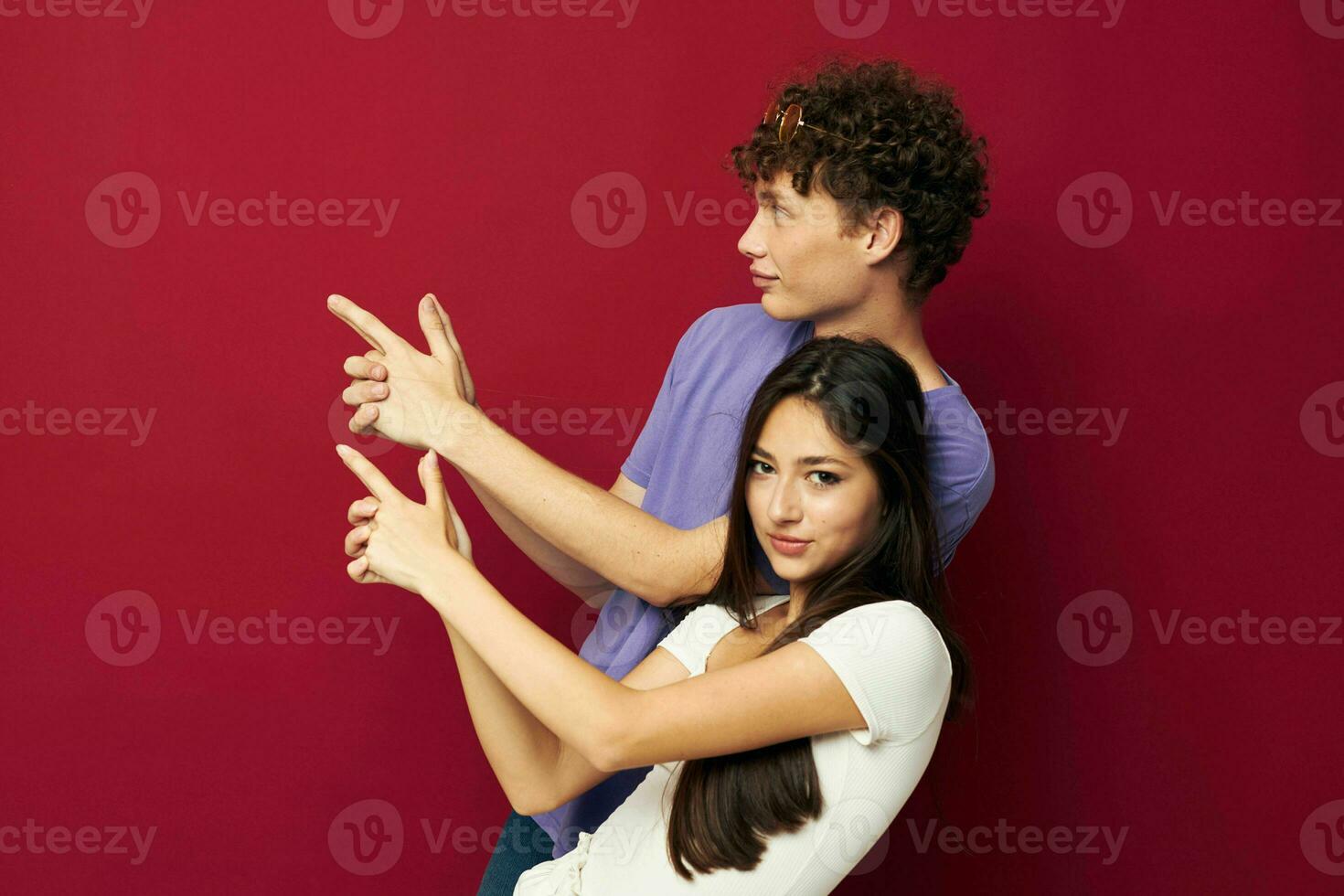 young man and girl summer style posing fashion emotions red background photo