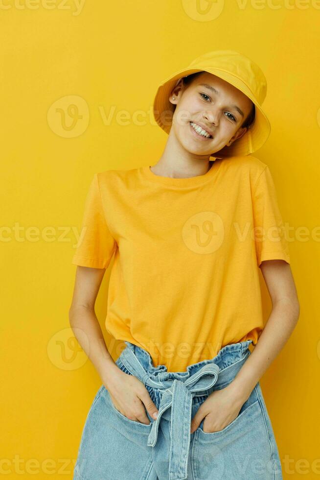 attractive woman in a yellow hat Youth style casual wear yellow background photo