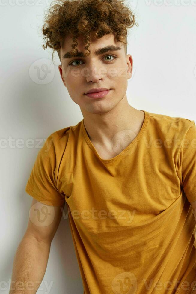 kinky guy in yellow t-shirts gesture hands emotions Lifestyle unaltered photo