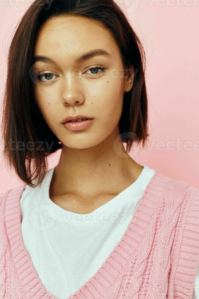 young woman pink feathers in hand posing casual wear Lifestyle unaltered photo