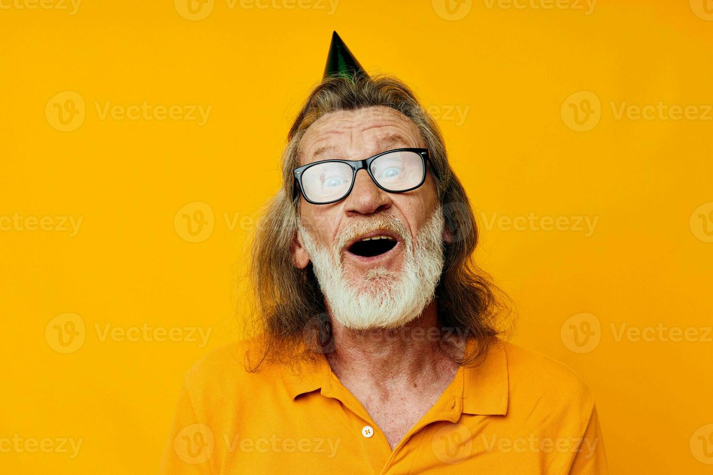 Portrait of happy senior man fun birthday cap on the head isolated background photo