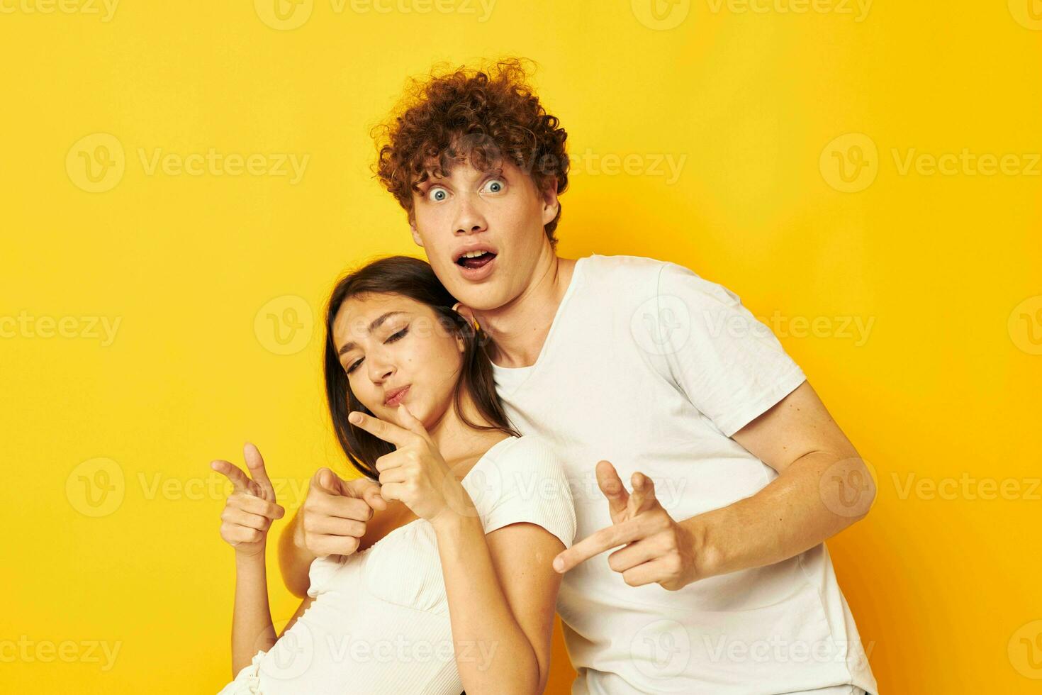 young boy and girl posing together in white t-shirts friendship yellow background unaltered photo