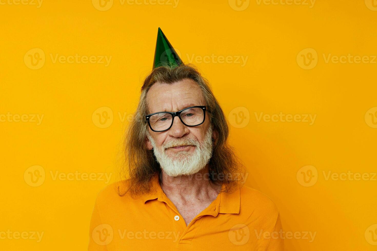 Portrait elderly man in a yellow t-shirt with a cap on his head fun yellow background photo