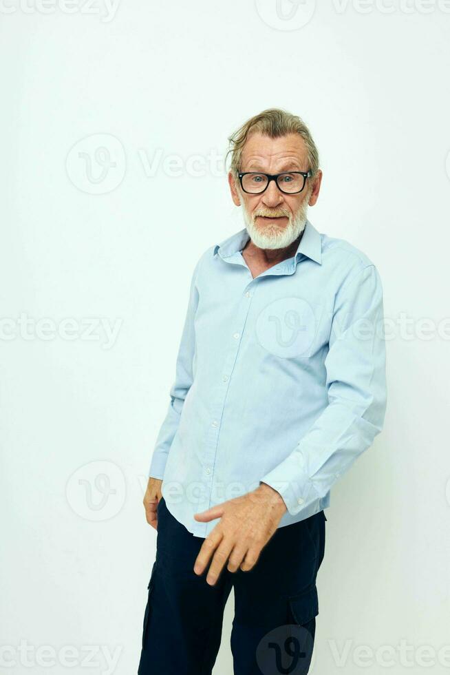 Photo of retired old man in shirt and glasses posing emotions light background