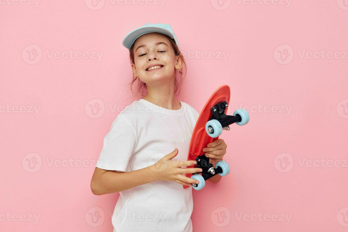 Portrait of happy smiling child girl with a skateboard in hand isolated background photo