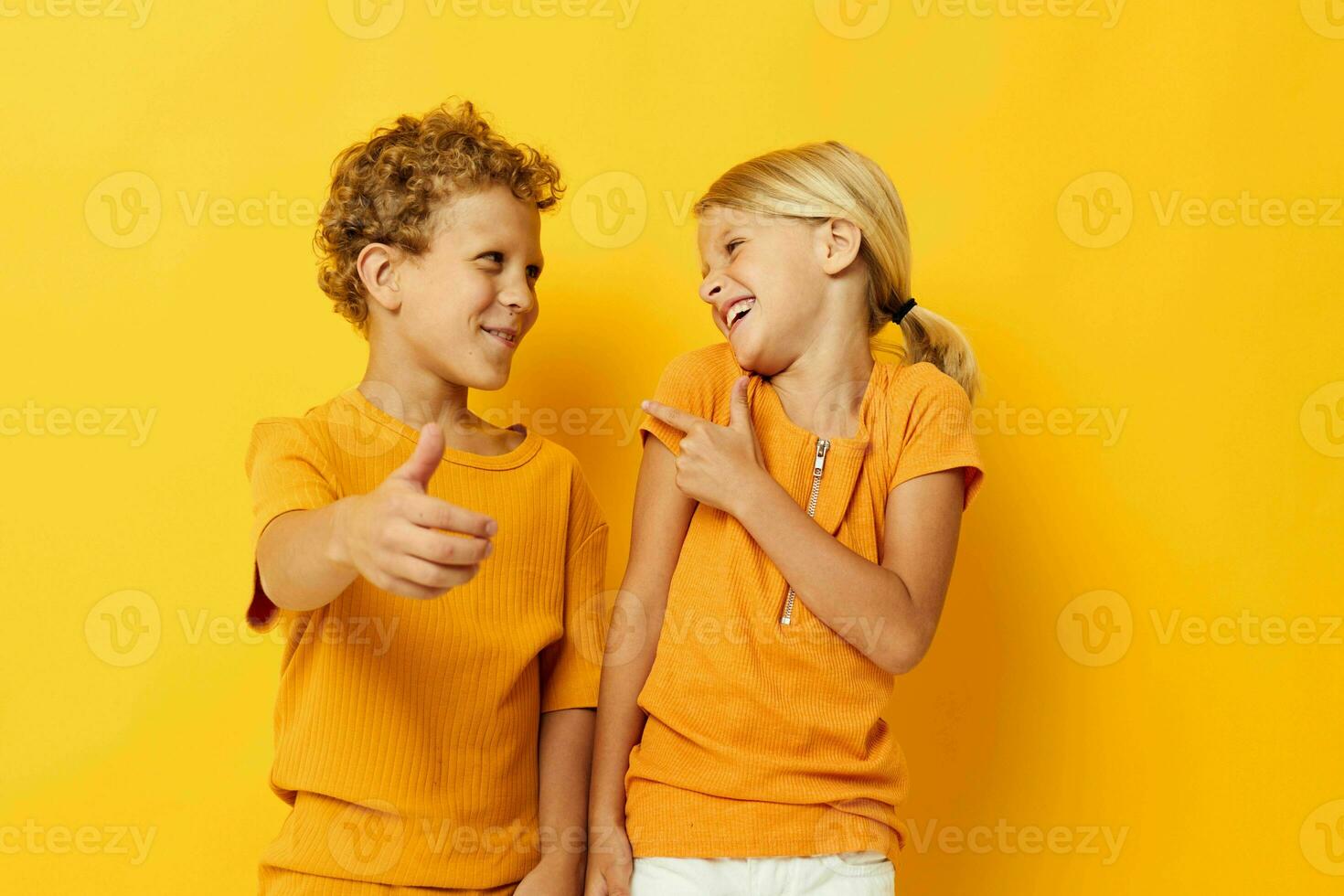 Cute stylish kids casual wear games fun together posing on colored background unaltered photo
