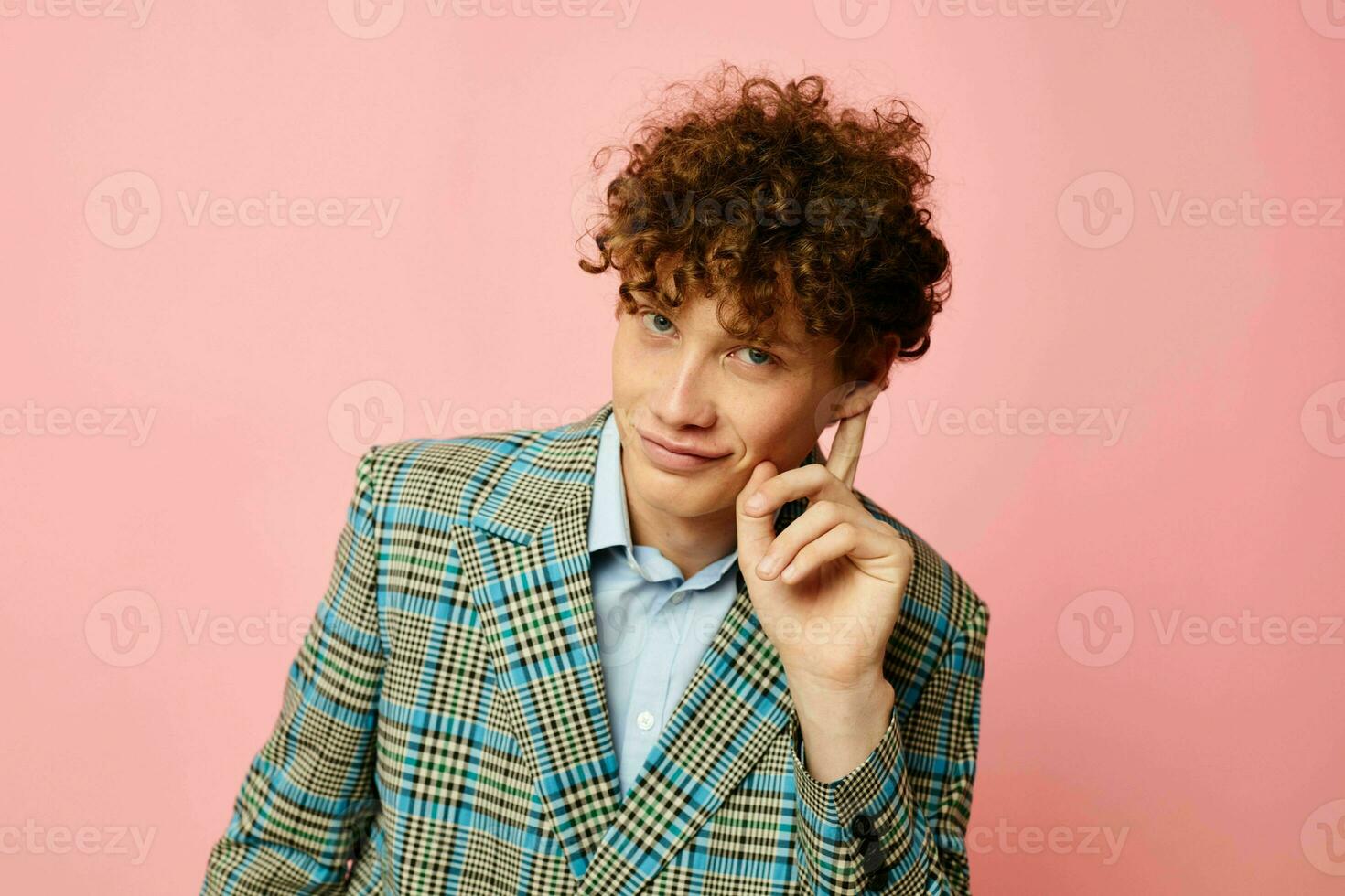 cute red-haired guy checkered blazer elegant style posing fashion pink background unaltered photo