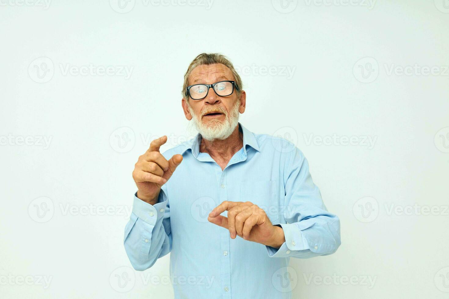 Photo of retired old man in shirt and glasses posing emotions light background