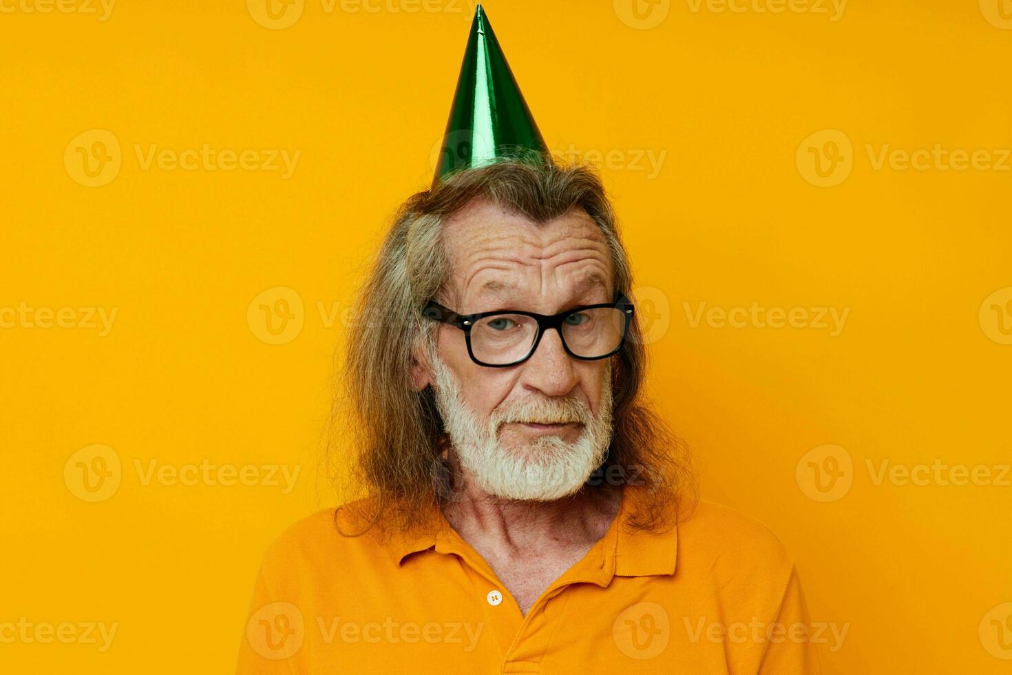 Portrait of happy senior man wearing glasses green cap on his head holiday emotions unaltered photo