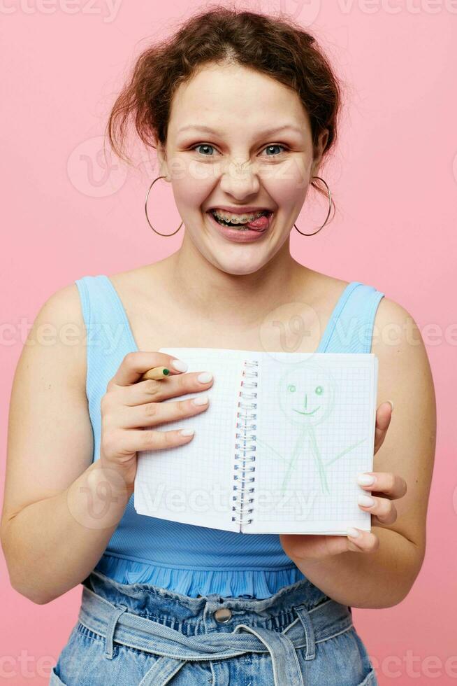 attractive woman learning with notebook and pen close-up unaltered photo