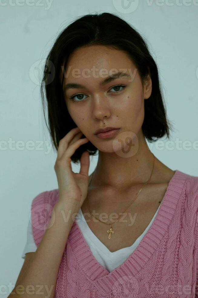 portrait of a young girl in a pink vest close-up charm photo