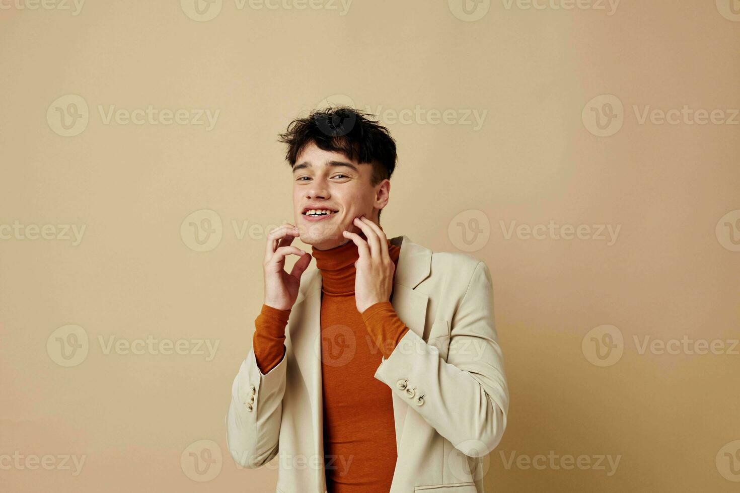 handsome guy posing with a phone in his hands in a jacket elegant style isolated background unaltered photo