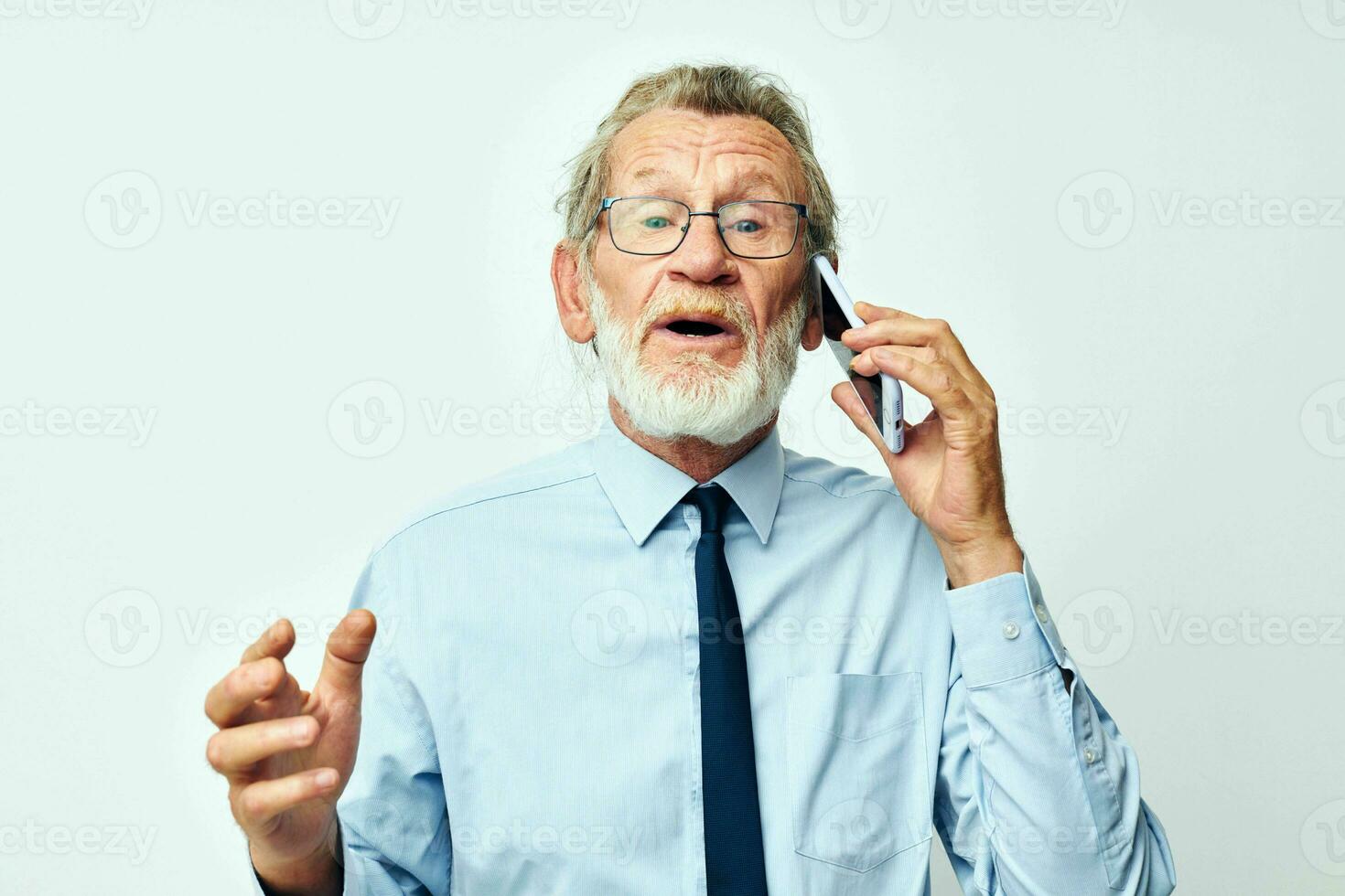 old man with phone in studio on white background talking photo