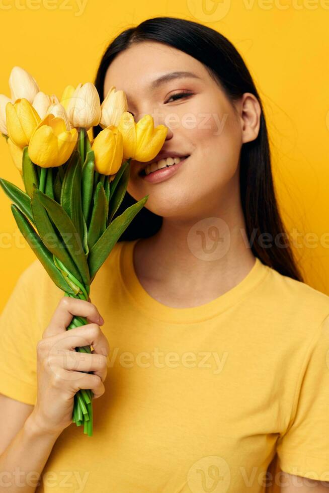 woman with Asian appearance bouquet of flowers in hands spring fun posing studio model unaltered photo