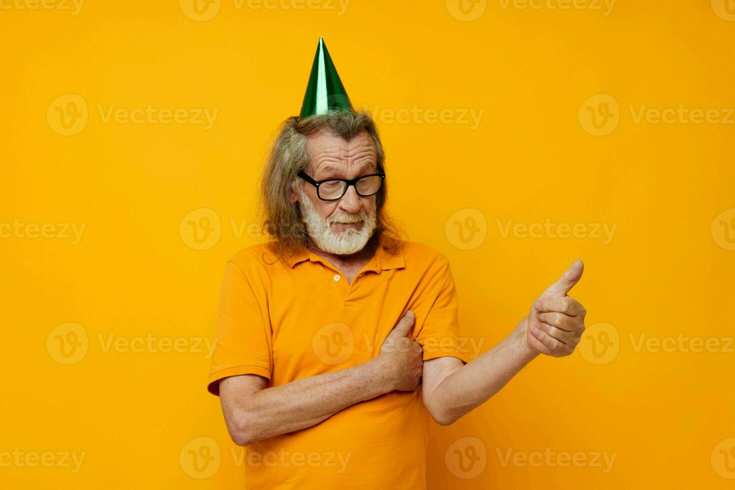 Portrait of happy senior man wearing glasses green cap on his head holiday emotions unaltered photo