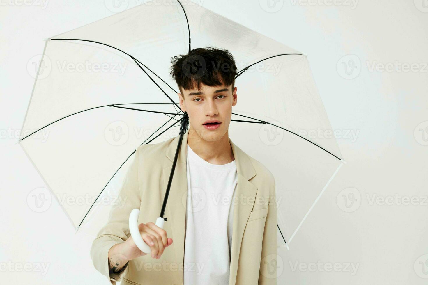 handsome guy transparent umbrella a man in a light jacket isolated background unaltered photo
