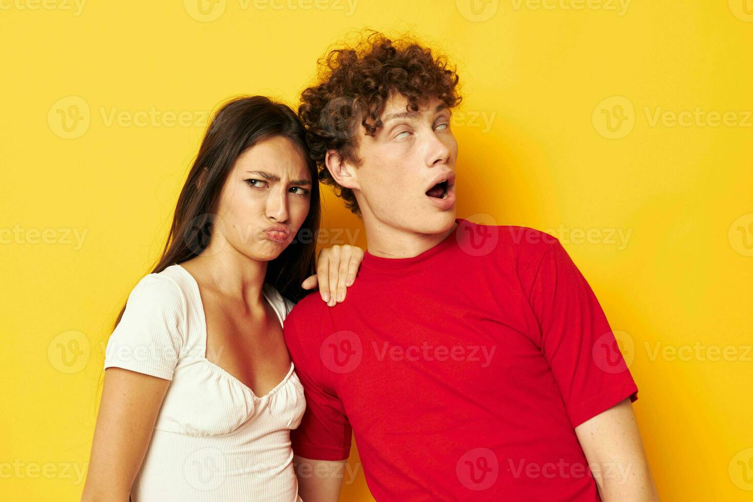 cute young couple together posing emotions close-up yellow background unaltered photo
