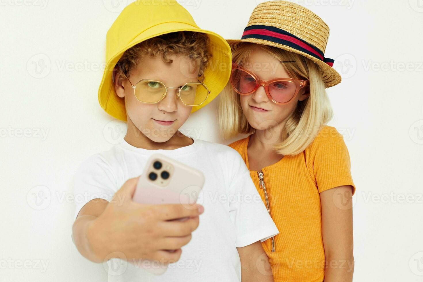 Cheerful boy and girl in fashionable glasses hats selfie posing photo