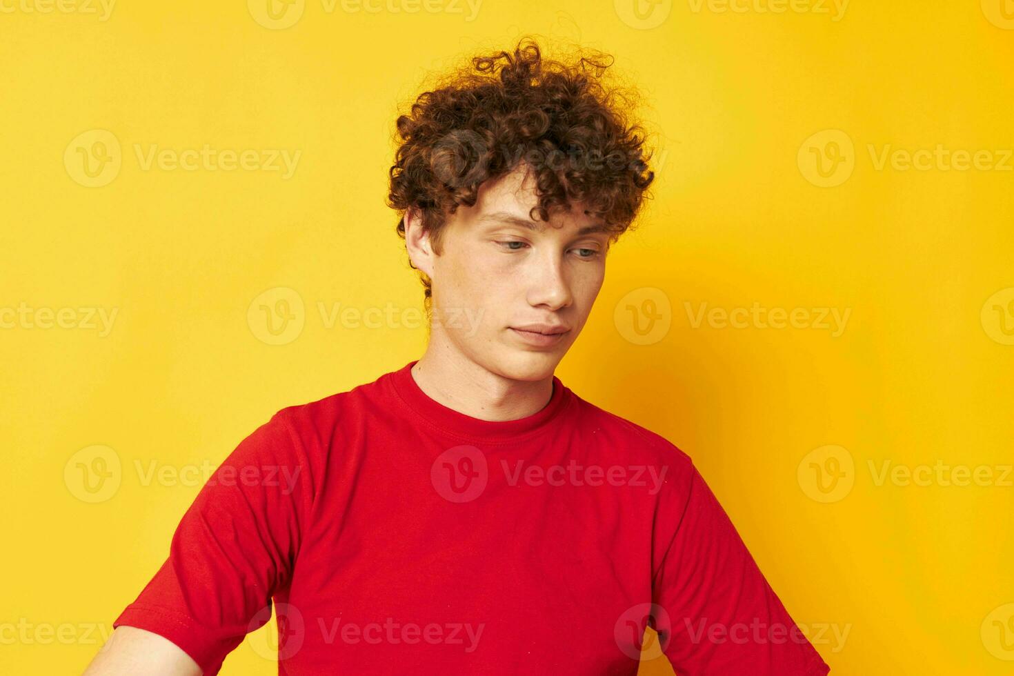 portrait of a young curly man summer style fashion posing isolated background unaltered photo