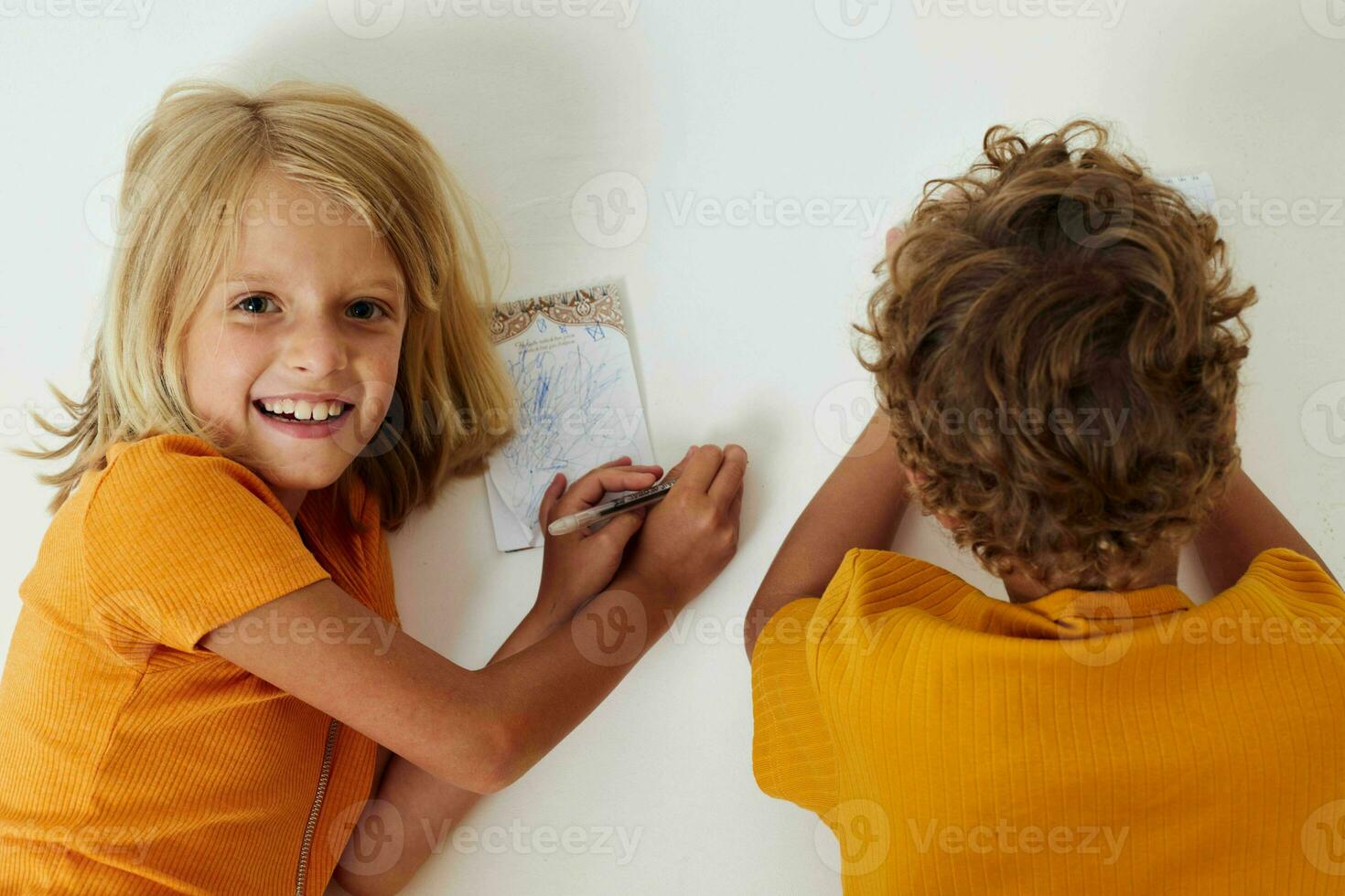 Small children emotions drawing together notepad and pencils isolated background unaltered photo