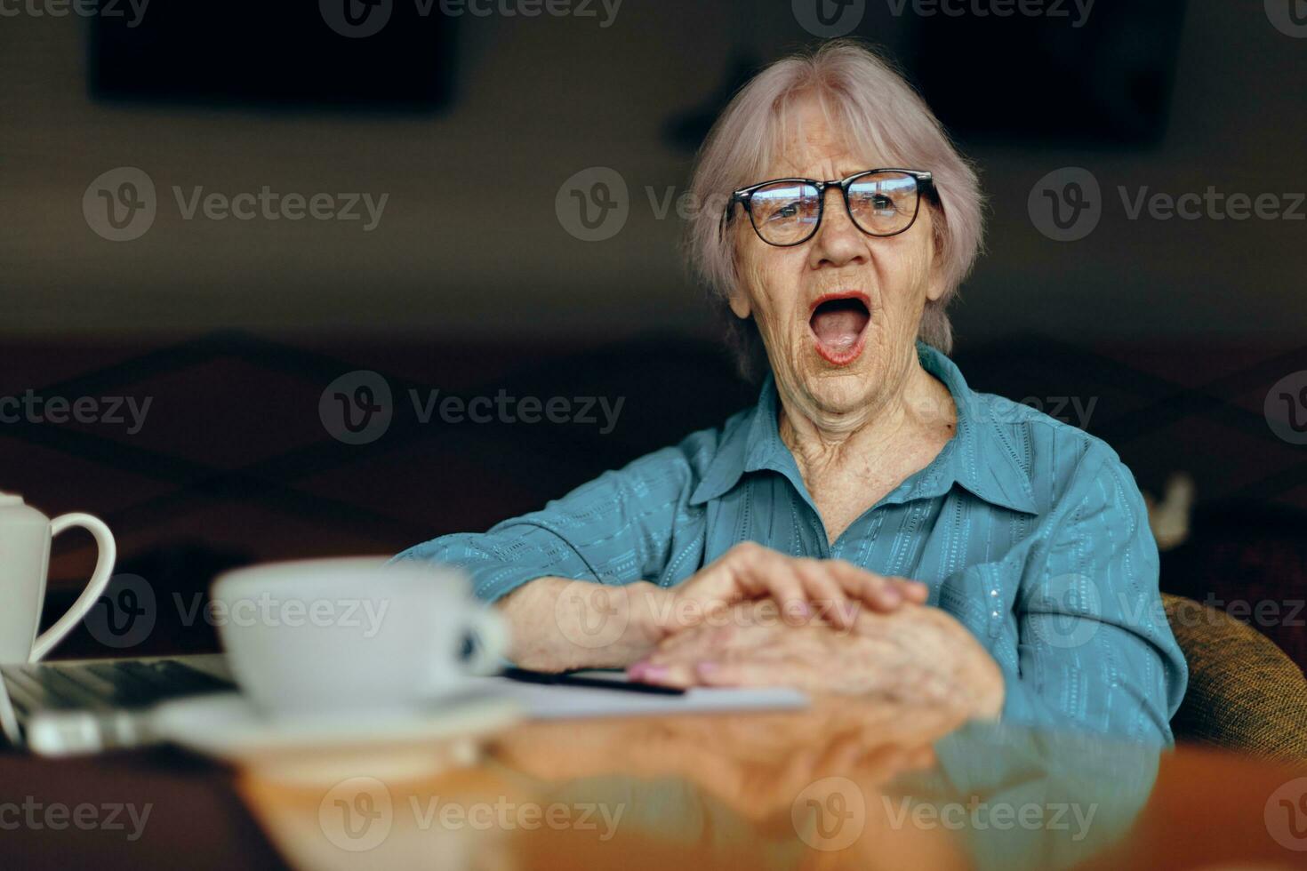 Happy senior woman in a cafe a cup of drink laptop Lifestyle unaltered photo