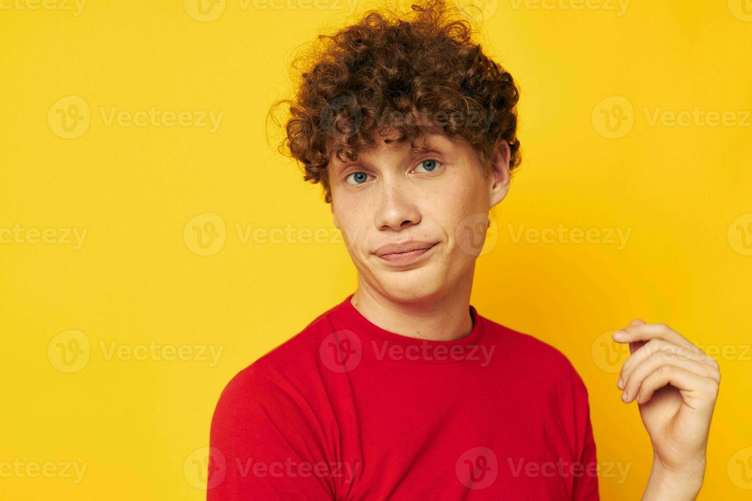 Young curly-haired man in a red t-shirt medical mask protection Lifestyle unaltered photo