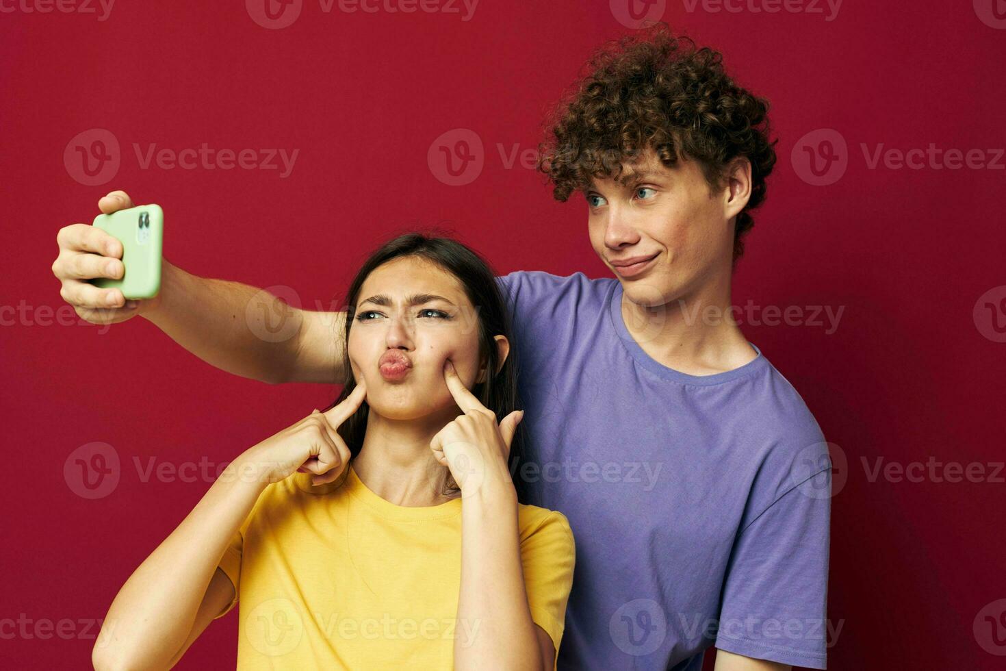 nice guy and girl modern style emotions fun phone red background photo