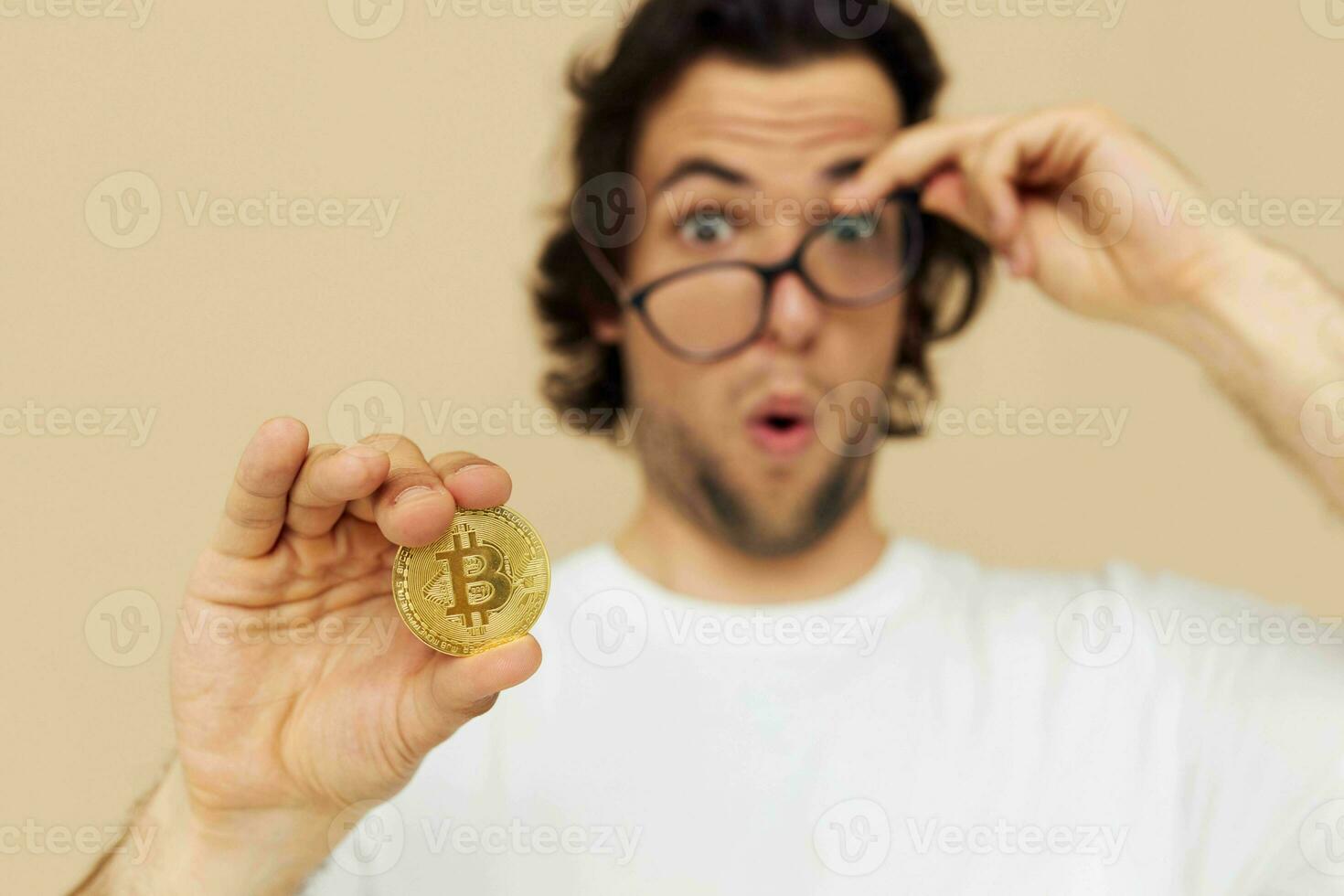 Attractive man in a white T-shirt with Bitcoin cryptocurrency isolated background photo