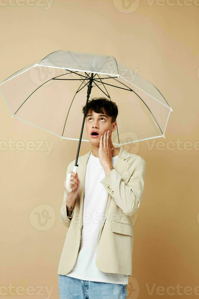 nice guy in a jacket with an open umbrella protection from the rain photo