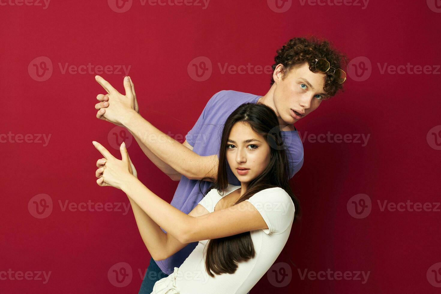 guy and girl posing studio red background photo