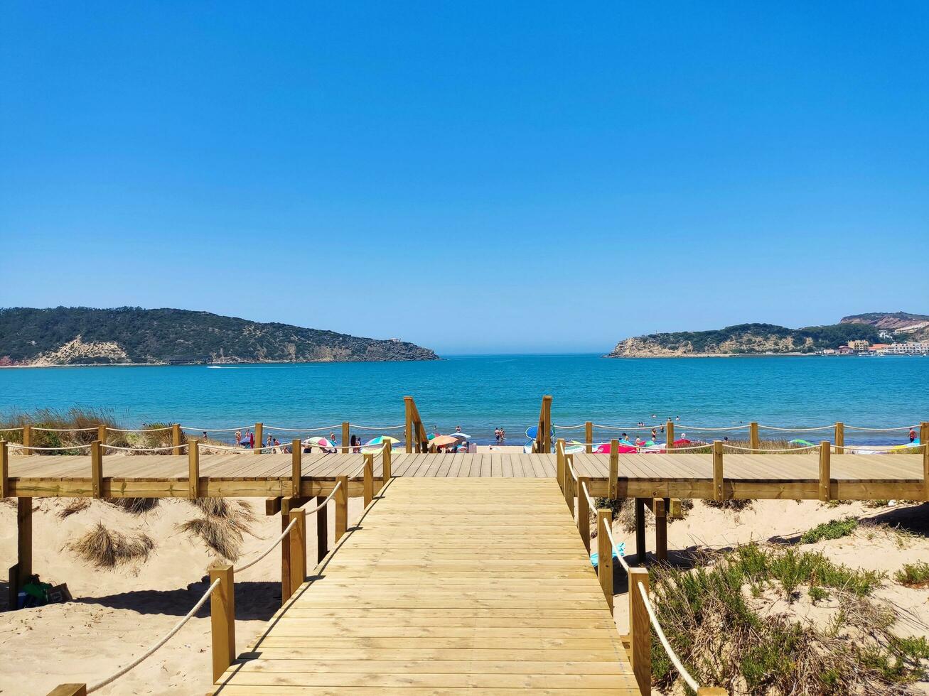 SAN MARTINHO, PORTUGAL  JULE 09 2022 beautiful beach on the bay and wooden walking paths photo