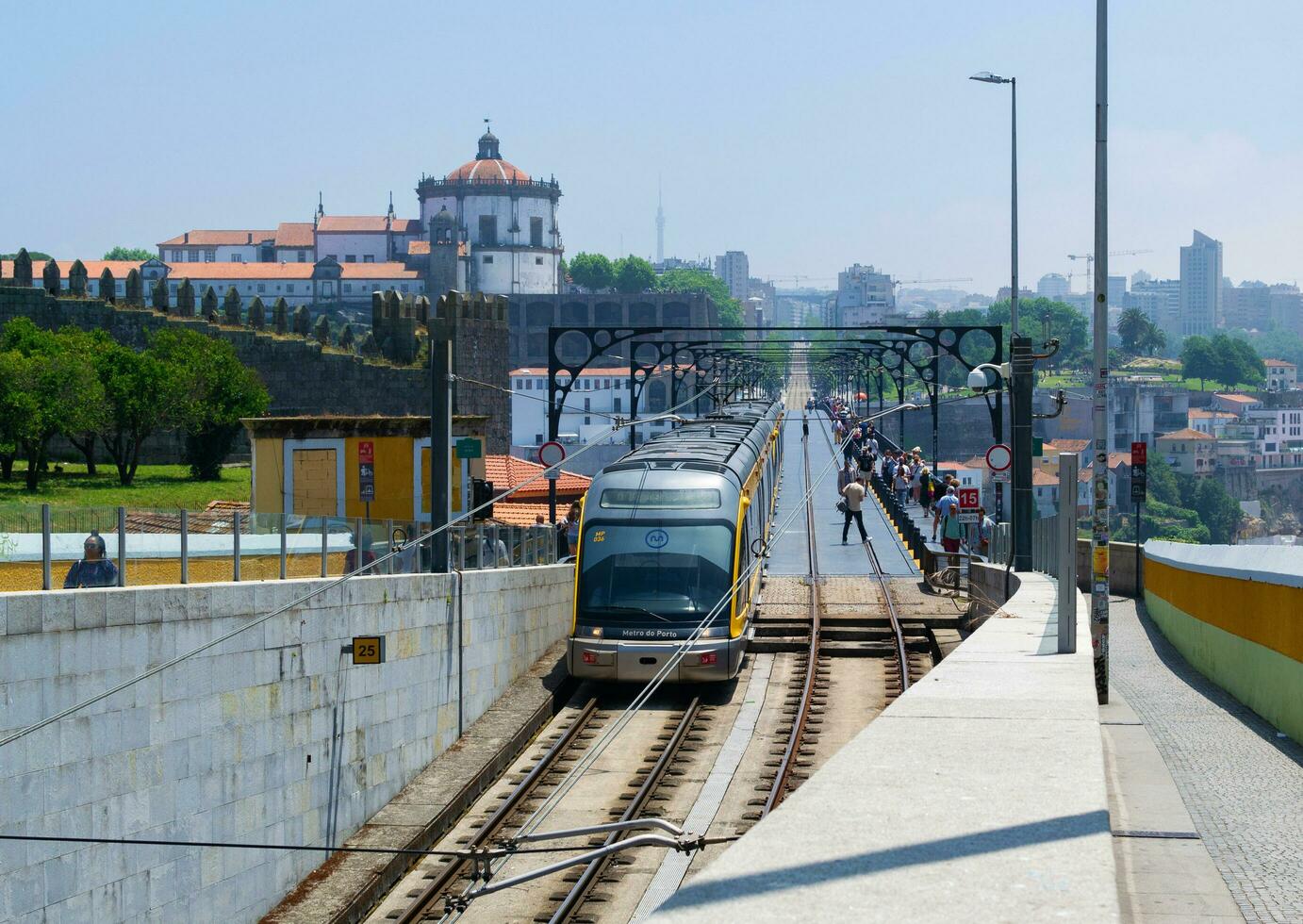 PORTO, PORTUGAL - JUNE 05, 2023 Metro rides over the bridge Ponte Luis I. Historic city, architecture of old town. Travel to Ribeira and Douro river. photo