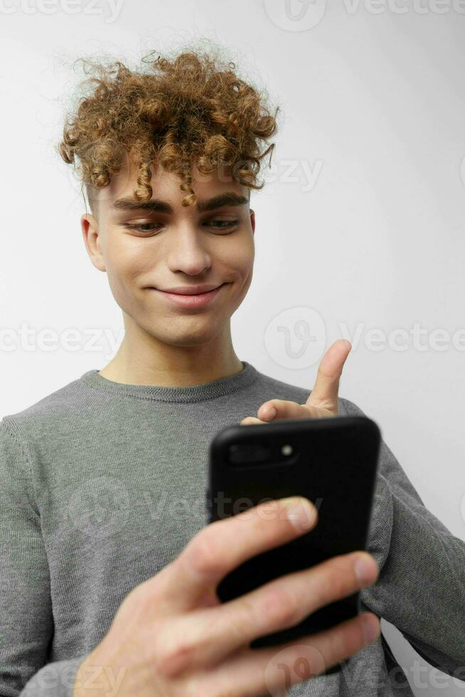 handsome young man with a phone in hand communication isolated background photo
