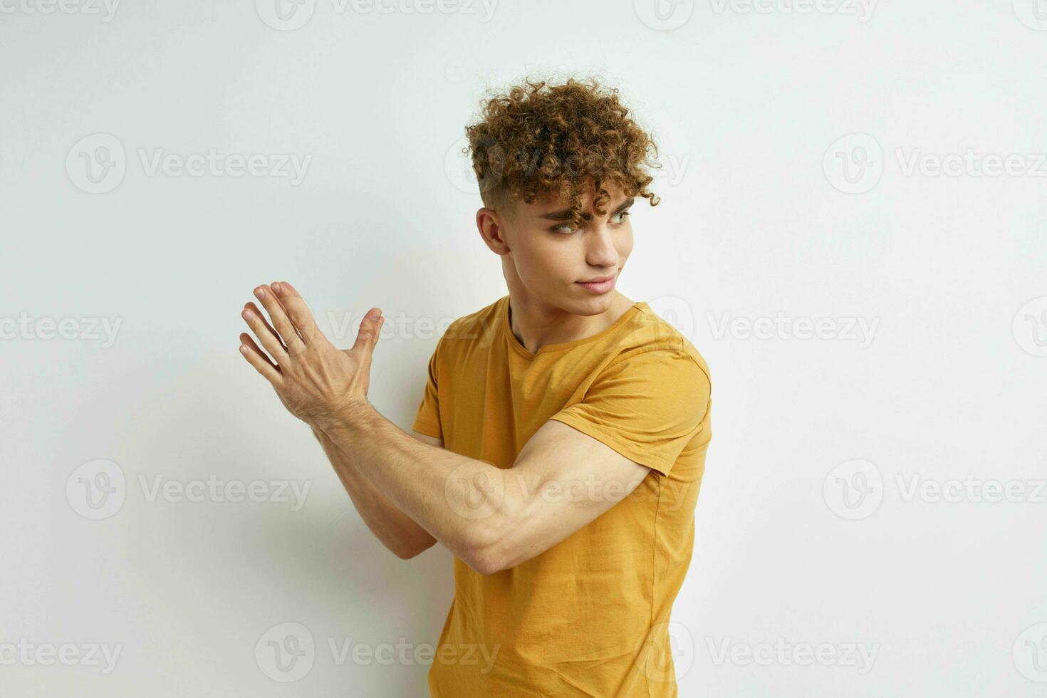 handsome guy in yellow t-shirts gesture hands emotions isolated background photo