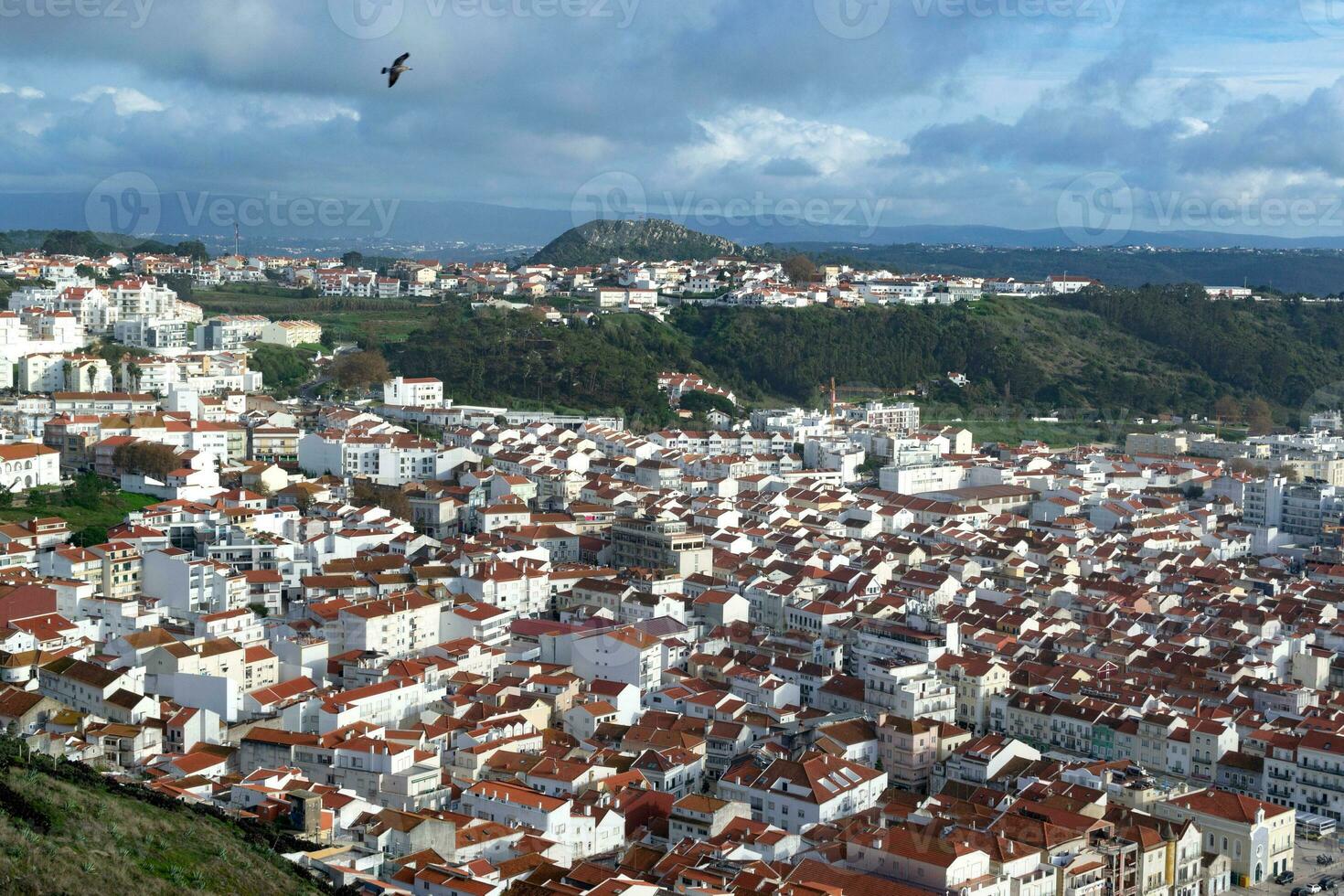 The city of Nazare in Portugal, the symbol of surfing. Coastline and view from above on the town. Tourist place with big waves. photo