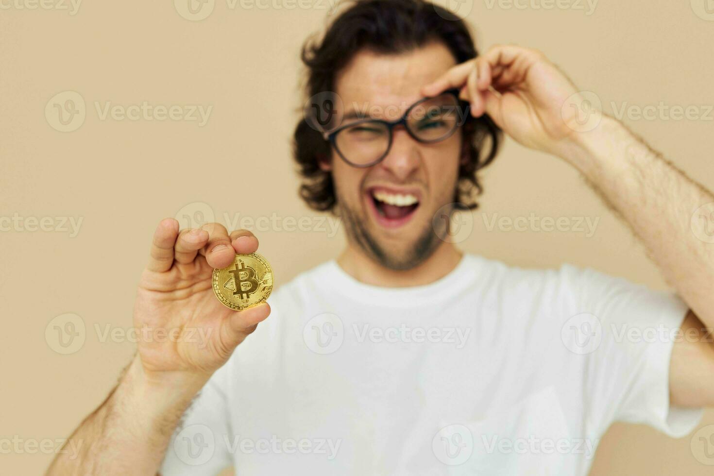 Cheerful man in a white T-shirt with Bitcoin cryptocurrency isolated background photo